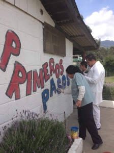 Re-painting the sign outside the clinic.
