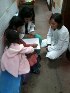 Playing with kids as they wait for their mother to finish her dental visit