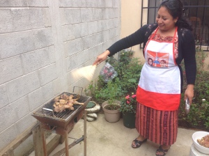 Gladys showing me how to keep the flames going on the barbeque