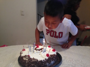 Gladys's son blowing out his birthday candles
